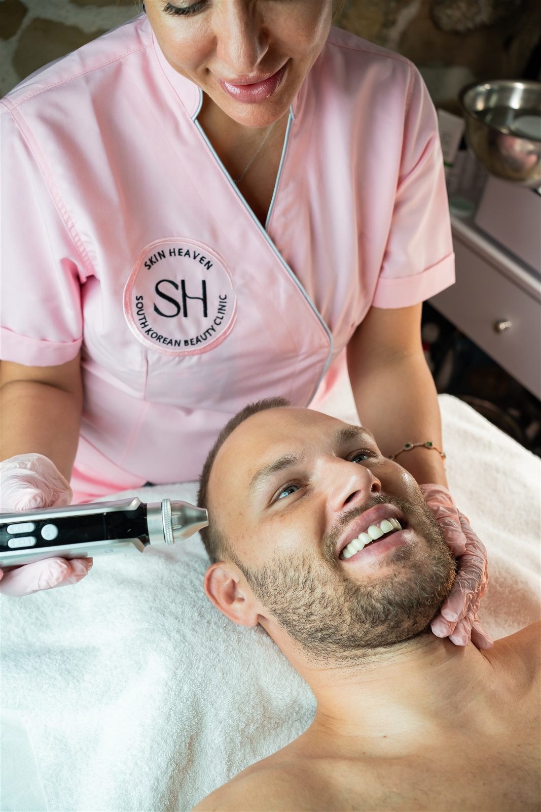 Man smiling during his facial treatment at Korean Skin Heaven Zürich